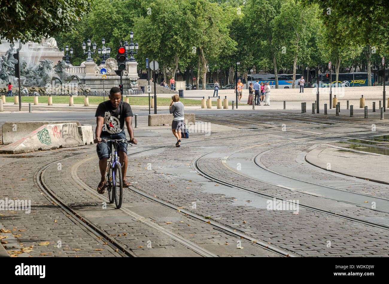 Man on bike by tramway route of Bordeaux. September 2013. France Stock Photo