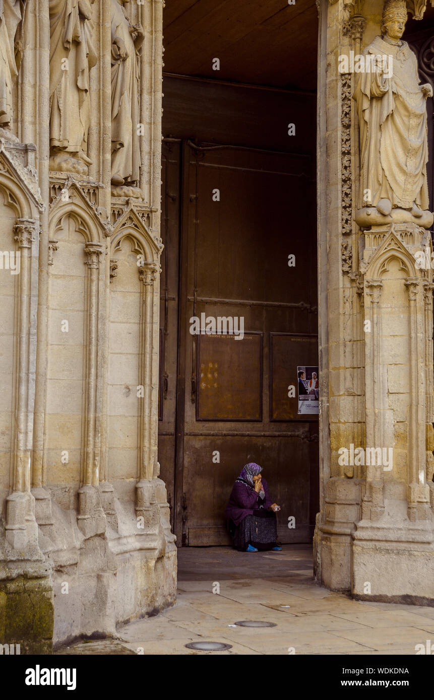 Woman begging at the cathedral door, in the city of Bordeaux, France, in September 2013 Stock Photo