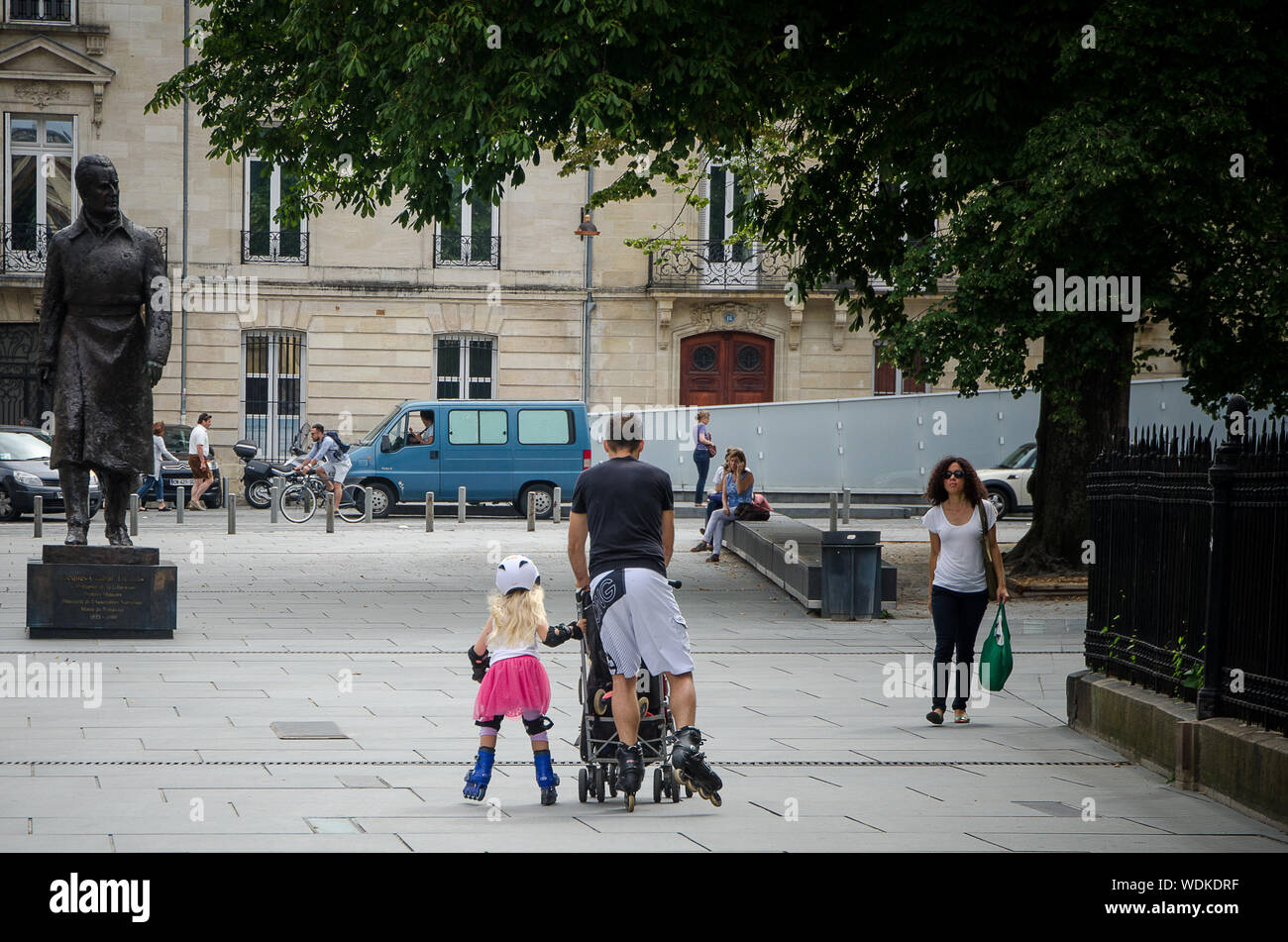 Woman walking down a street in Bordeaux. September 2013. France Stock Photo