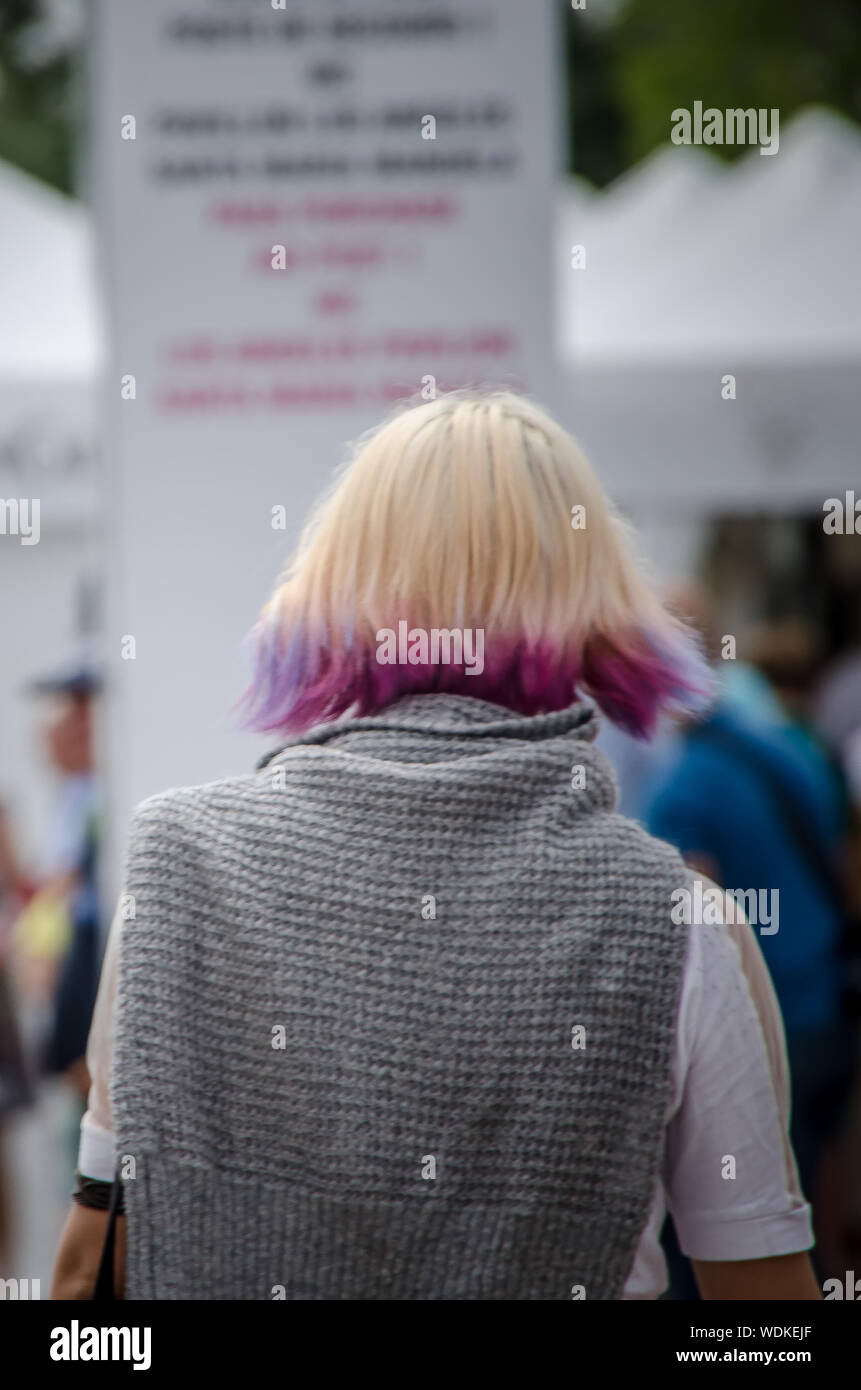 Woman from the back with blond hair and pink city of Bordeaux, France, in September 2013 Stock Photo