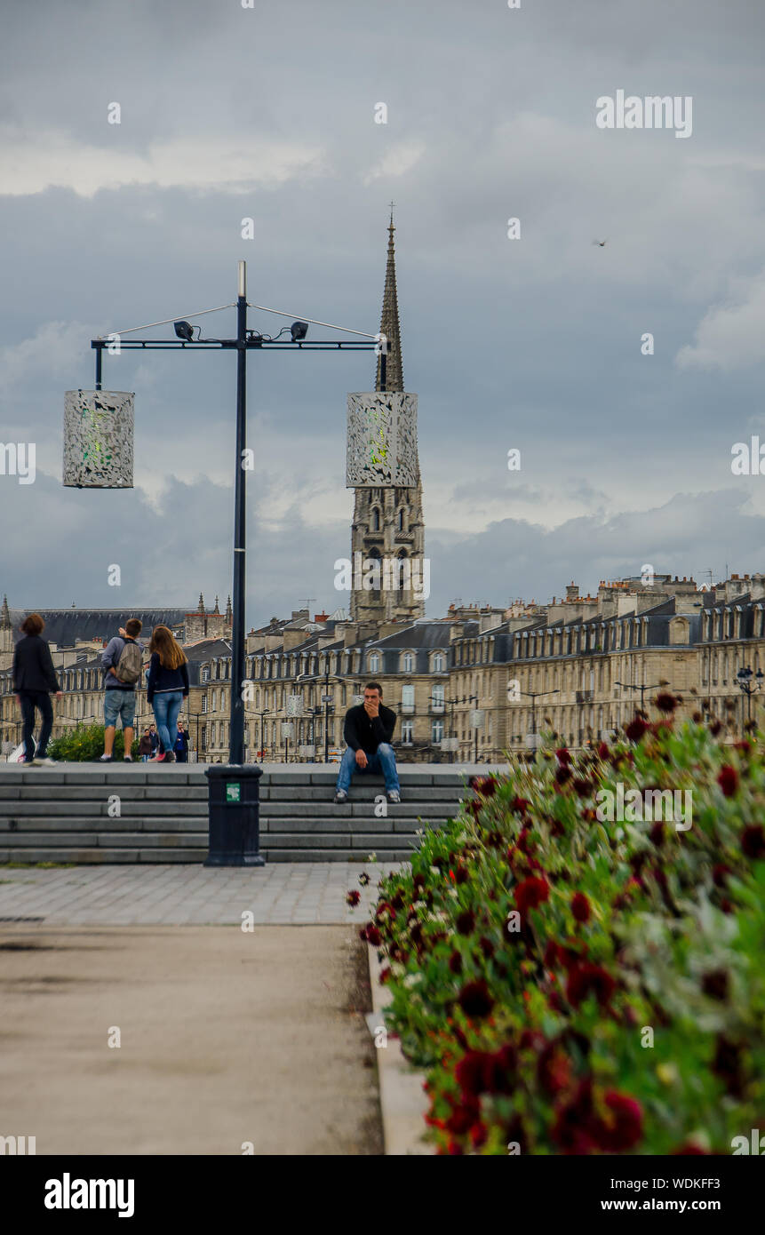 Man sitting in the Place de la Bourse in the city of Bordeaux, France, in September 2013 Stock Photo