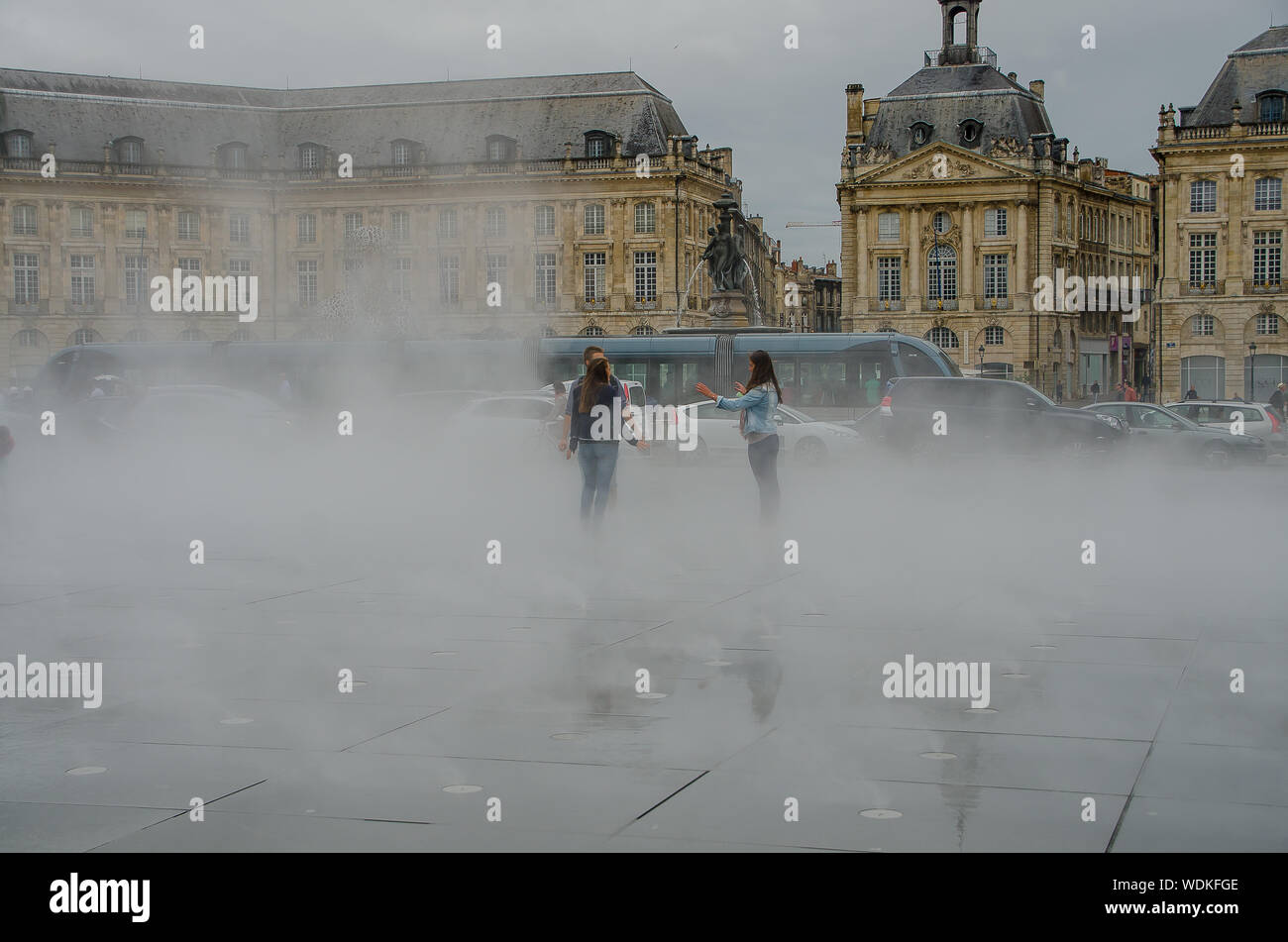 Young people playing in the water mirror of the Place de la Bourse in Bordeaux. September 2013. France Stock Photo