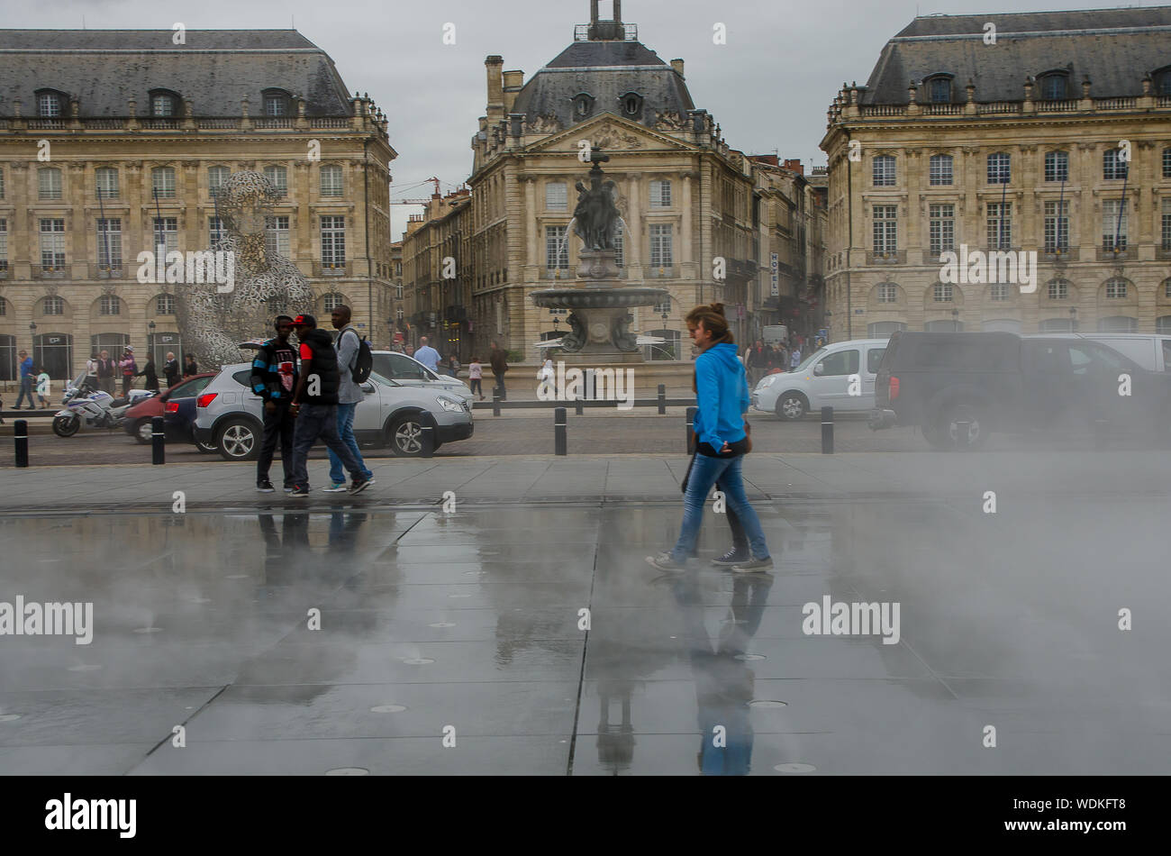 People walking in the water mirror of the Place de la Bourse in Bordeaux. September 2013. France Stock Photo
