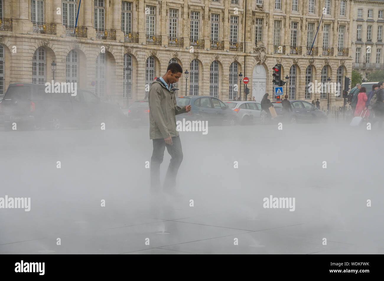 People walking in the water mirror of the Place de la Bourse in Bordeaux. September 2013. France Stock Photo