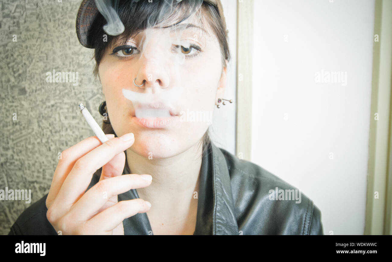 Young woman smoking cigarette cigarette hi-res stock photography and