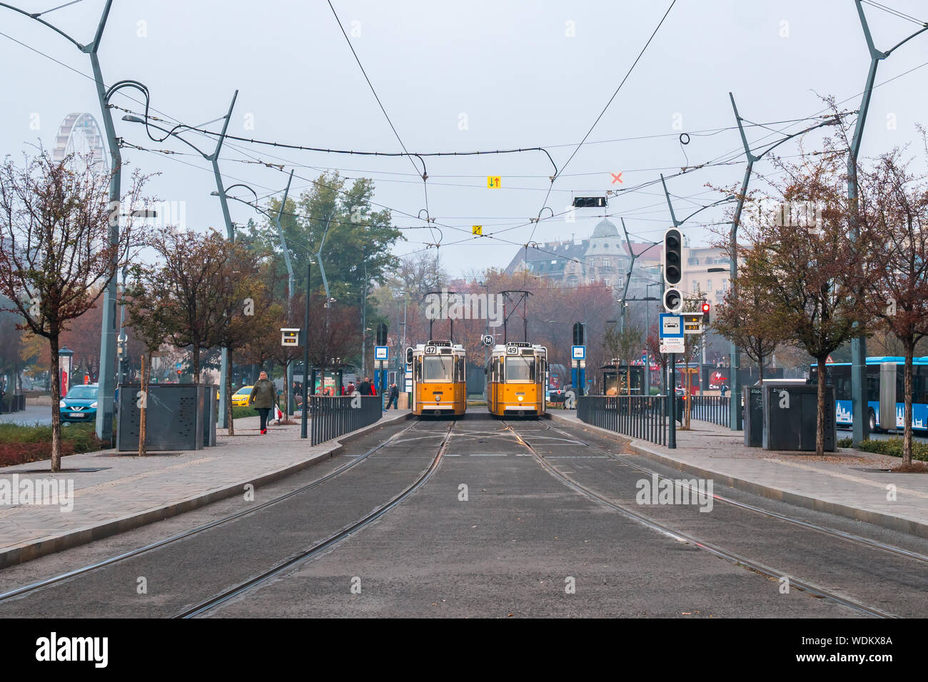 Budapest, Hungary - 11.12.2018: Old style yellow trams in the middle of Budapest streets. Transportation. Stock Photo