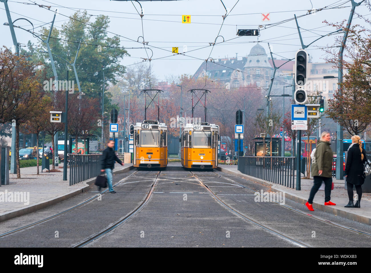 Budapest, Hungary - 11.12.2018: Old style yellow trams in the middle of Budapest streets. Transportation. Stock Photo