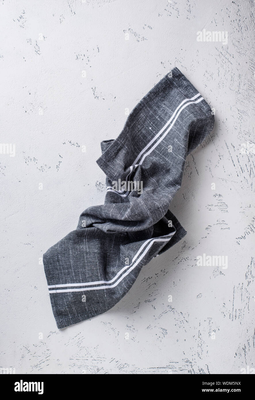 Gray linen napkin on light table Stock Photo