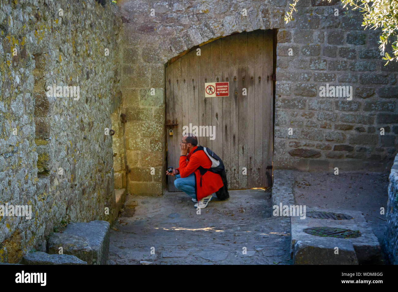 Tourist with backpack on the Mont Saint Michel. Stock Photo