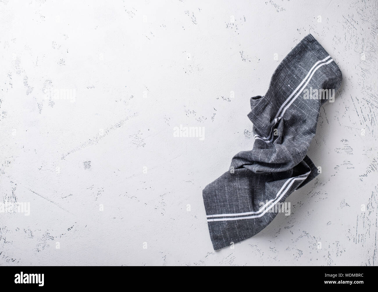 Gray linen napkin on light table Stock Photo
