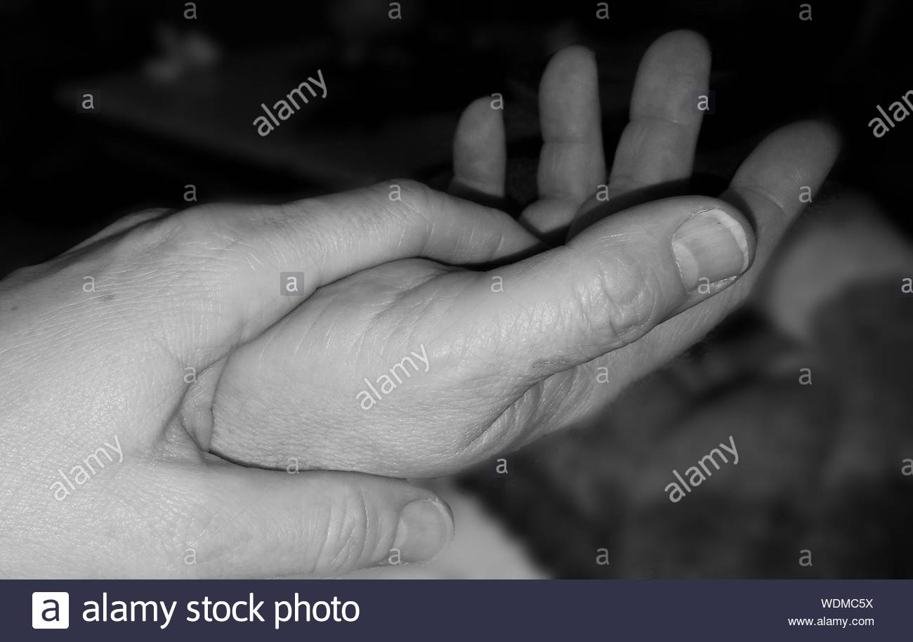 Cropped Hands Of Couple At Night Stock Photo Alamy