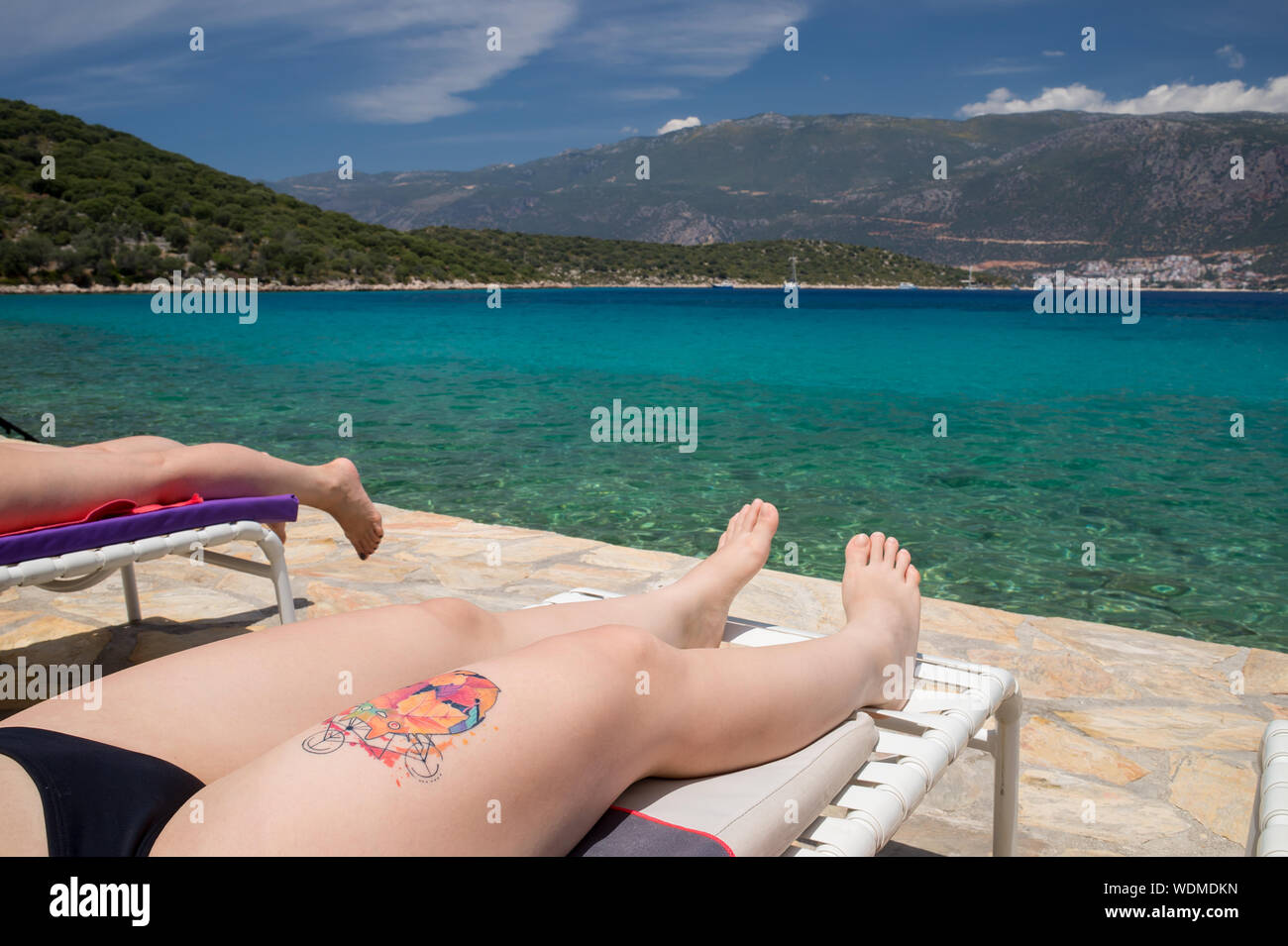 Young Woman With Tattoo Sunbathing On Sunbed By Sea Stock Photo - Alamy Young Woman With Tattoo Sunbathing On Sunbed By Sea Stock Photo - Alamy
