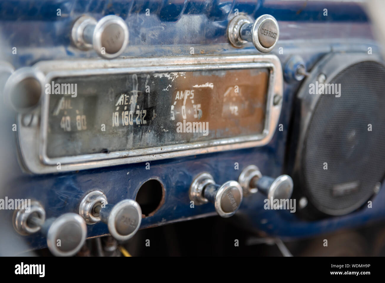 Dashboard at front of abandoned vintage truck with ammeter, oil indicator, various knobs Stock Photo