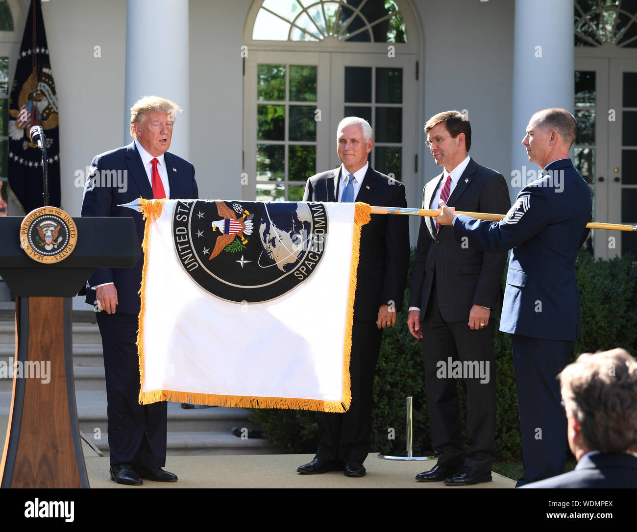 Washington, United States. 29th Aug, 2019. President Donald Trump, Vice President Mike Pence and Secretary of Defense Mark Esper look on as the flag of the Space Command is unfurled in the Rose Garden of the White House in Washington, DC on Thursday, August 29, 2019. The President announced Space Command's official establishment, or to be more precise, it's re-establishment after it had been eliminated in 2002. Photo by Pat Benic/UPI Credit: UPI/Alamy Live News Stock Photo