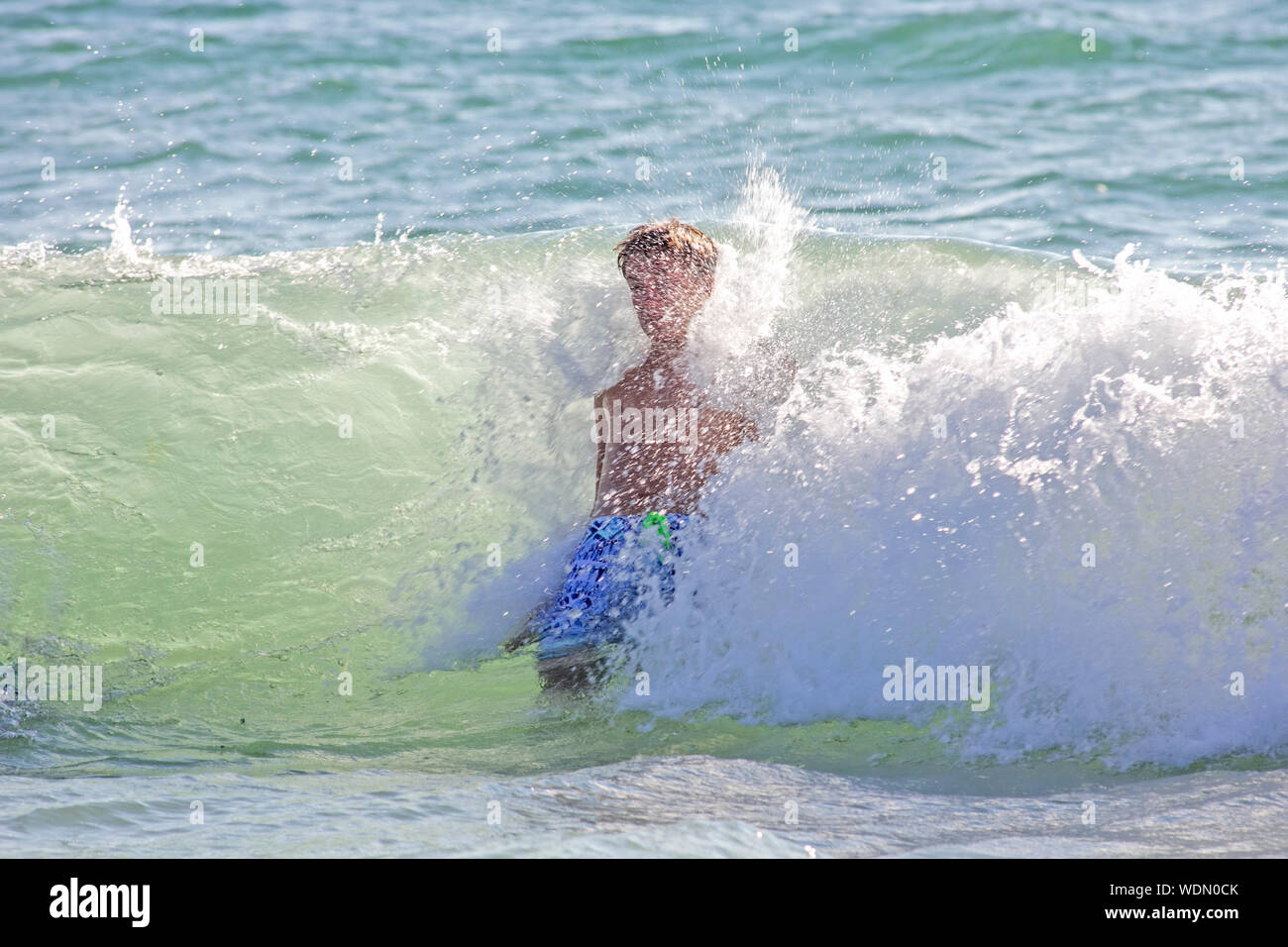 Boy splashing in water hi-res stock photography and images - Alamy