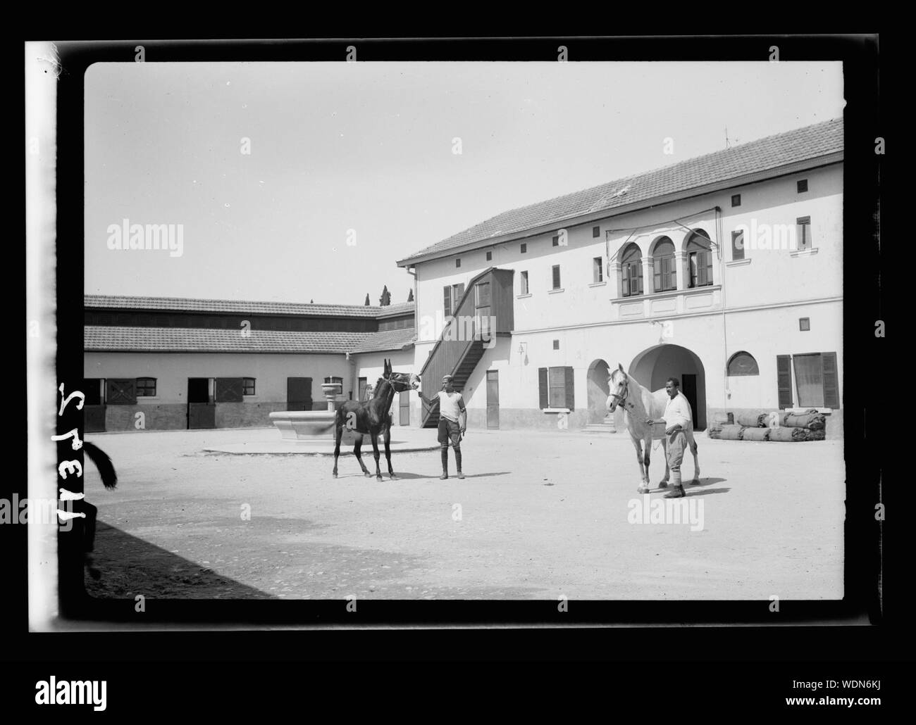 Government Stud Farm, Acre. A courtyard of horse stables Abstract/medium: G. Eric and Edith Matson Photograph Collection Stock Photo