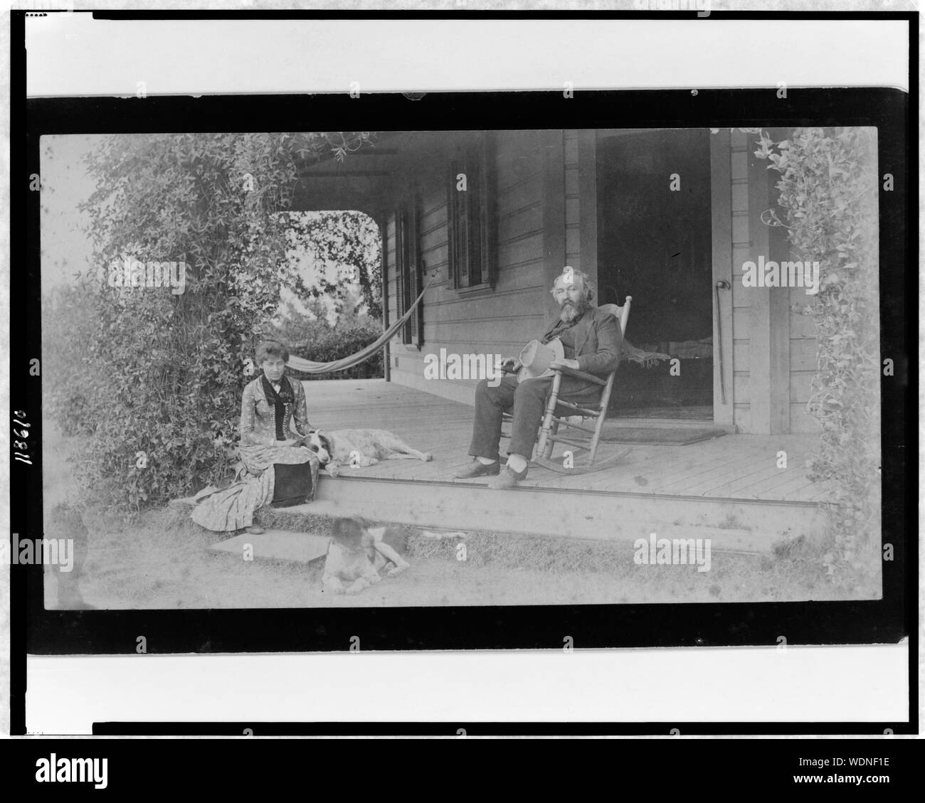 Grace Ellery Channing Stetson seated with her uncle, William Douglas O'Connor, on porch of the Channing home, 170 N. Orange Grove Ave., Pasadena, California Abstract/medium: 1 photographic print. Stock Photo