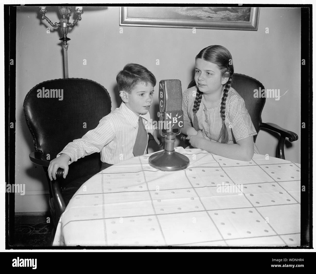 Graela and Dieter Tannenberg, daughter of the First Secretary of the German Embassy and Frau Tannenberg, who will take part in the International Children's Christmas Broadcast which will go over the air from the Shoreham Hotel on December 20. This function is one of the feature broadcasts of the year that goes out of the United States to all the countries of the world. It is arranged by the Greater National Committee in cooperation with the National Broadcasting Company. Abstract/medium: 1 negative : glass  4 x 5 in. or smaller Stock Photo