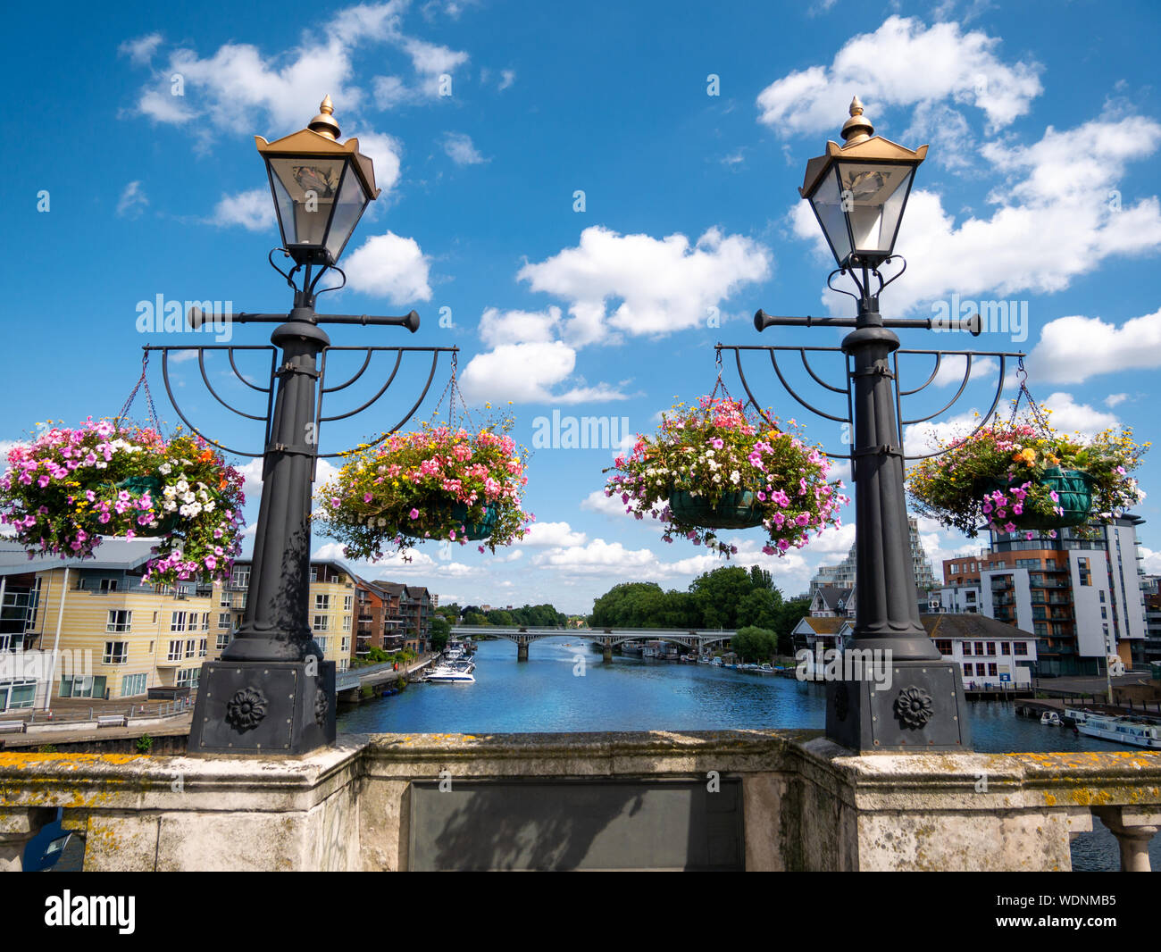 Ornamental flowers and medieval lamps on the wall of Kingston bridge in a sunny day Stock Photo