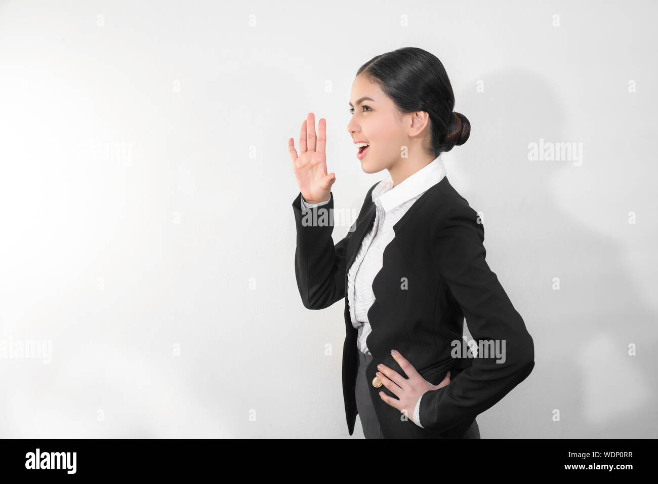 Beautiful Businesswoman Shouting Against White Background Stock Photo