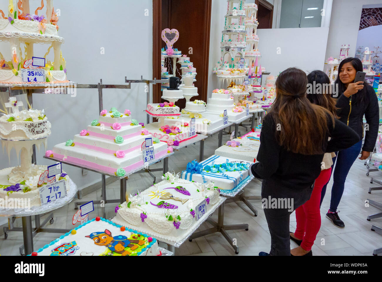 Local females looking at fancy cakes at PAS ELERIA IDEAL, a local bakery, mexico city, mexico Stock Photo