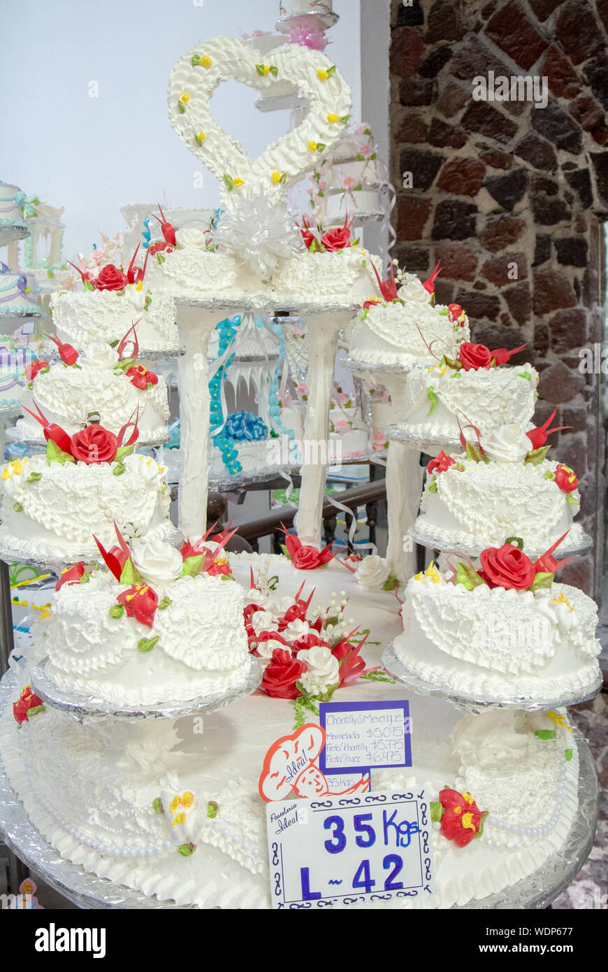 White wedding cakes with red rose at PAS ELERIA IDEAL, a local bakery, mexico city, mexico Stock Photo
