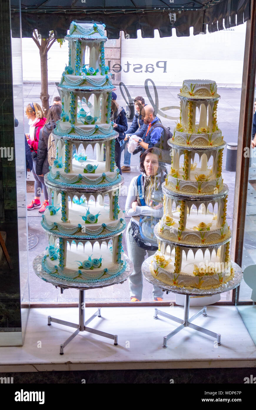 mexico city, mexico, A woman looking at decorative cakes at window case of PAS ELERIA IDEAL that is a bakery in mexico city, Editorial only. Stock Photo
