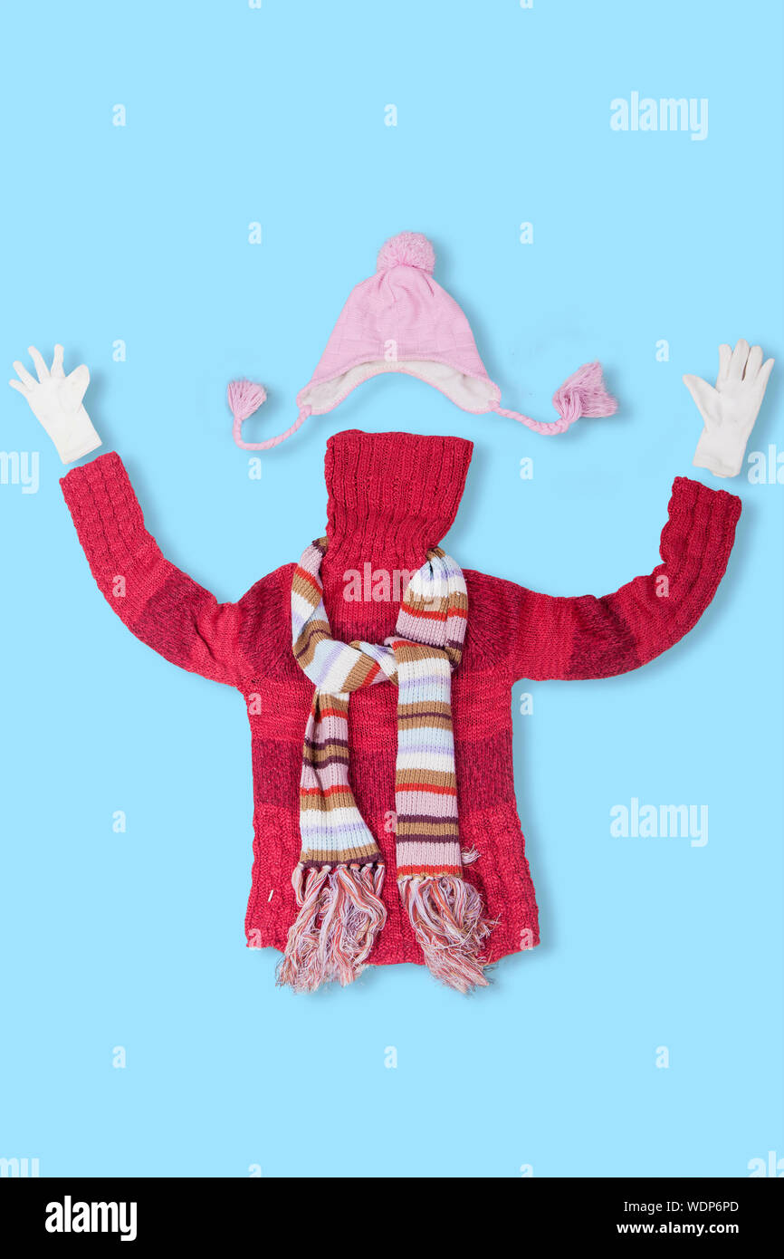 Directly Above Shot Of Winter Clothing Against Blue Background Stock Photo
