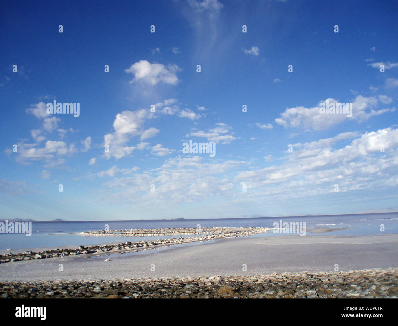 Utah - August 22, 2007: Spiral jetty and sky seen from the rocky shore, Robert Smithson's masterpiece earthwork, on the north side of the Great Salt L Stock Photo
