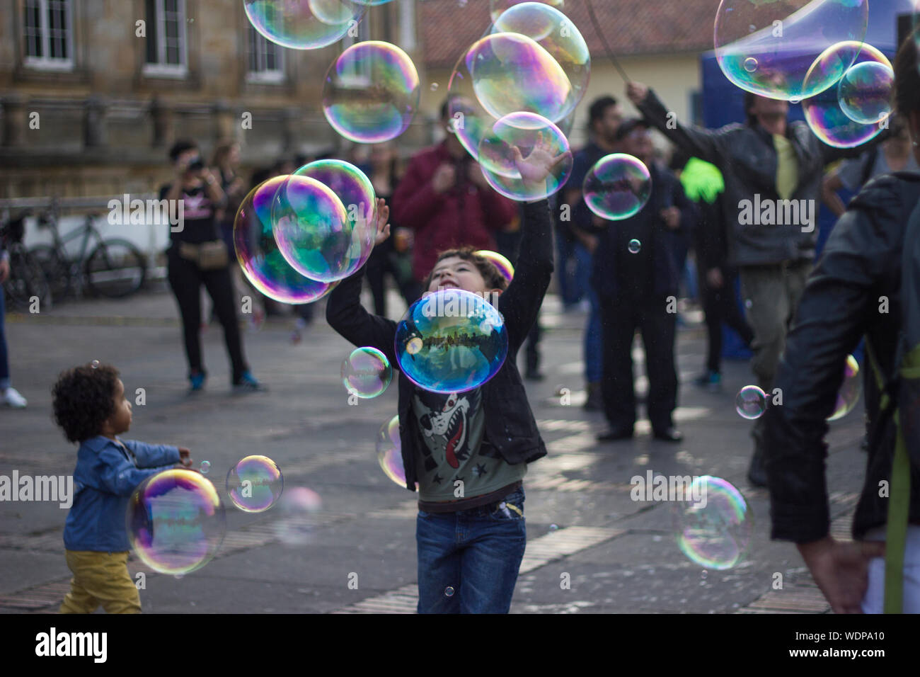 People With Bubbles On Street In City Stock Photo Alamy