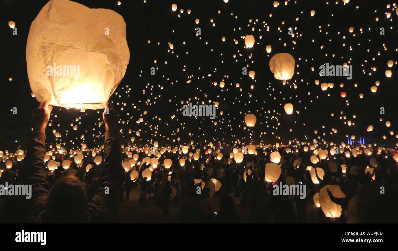 Crowd Releasing Lanterns At Festival Stock Photo