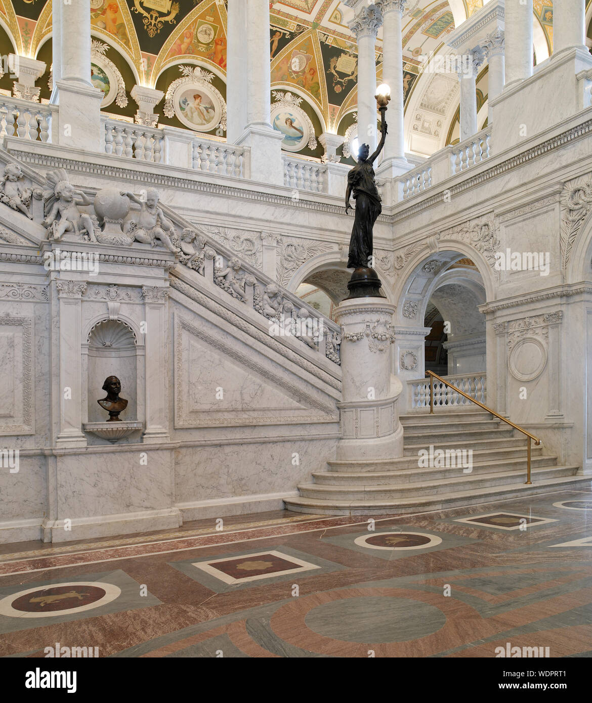 Great Hall. View of grand staircase and bronze statue of female figure on newel post holding a torch of electric light. Library of Congress Thomas Jefferson Building, Washington, D.C. Stock Photo