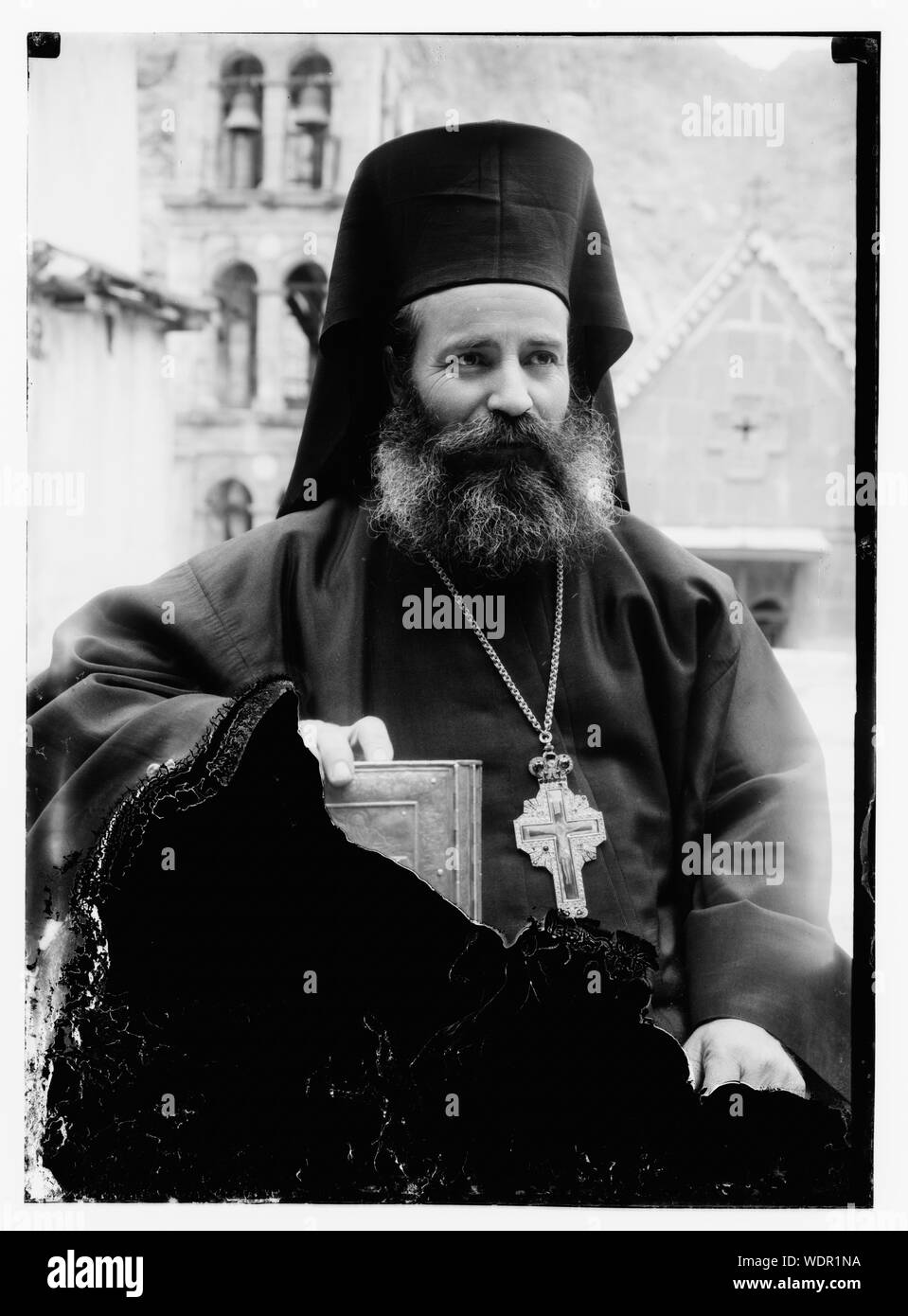 Greek Orthodox priest at St. Catherine's Monastery in the Sinai holding prized manuscript with silver cover from the library Abstract/medium: G. Eric and Edith Matson Photograph Collection Stock Photo