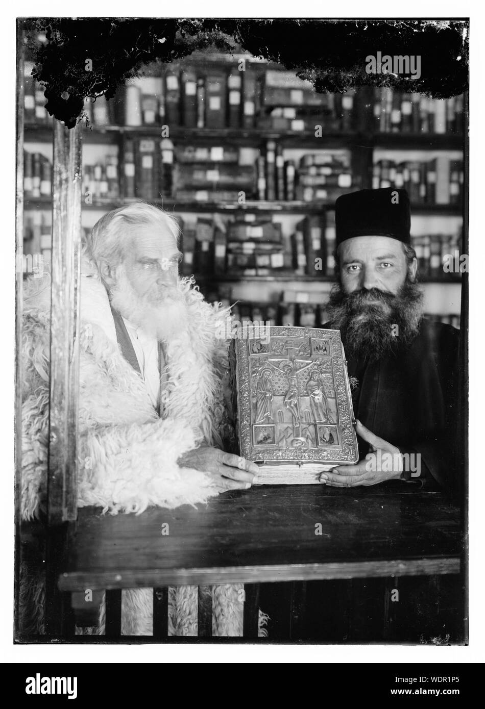 Greek Orthodox priests at St. Catherine's Monastery in the Sinai holding prized manuscript with silver covers from their library Abstract/medium: G. Eric and Edith Matson Photograph Collection Stock Photo