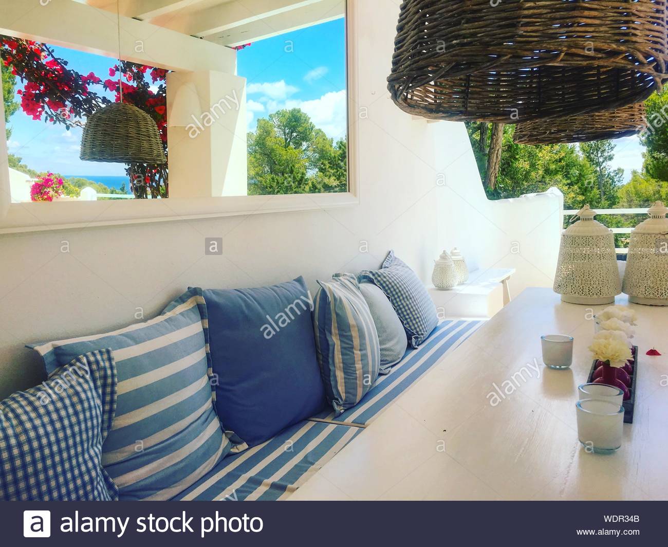 Rectangular White Wooden Table Near Couch With Blue Throw Pillows