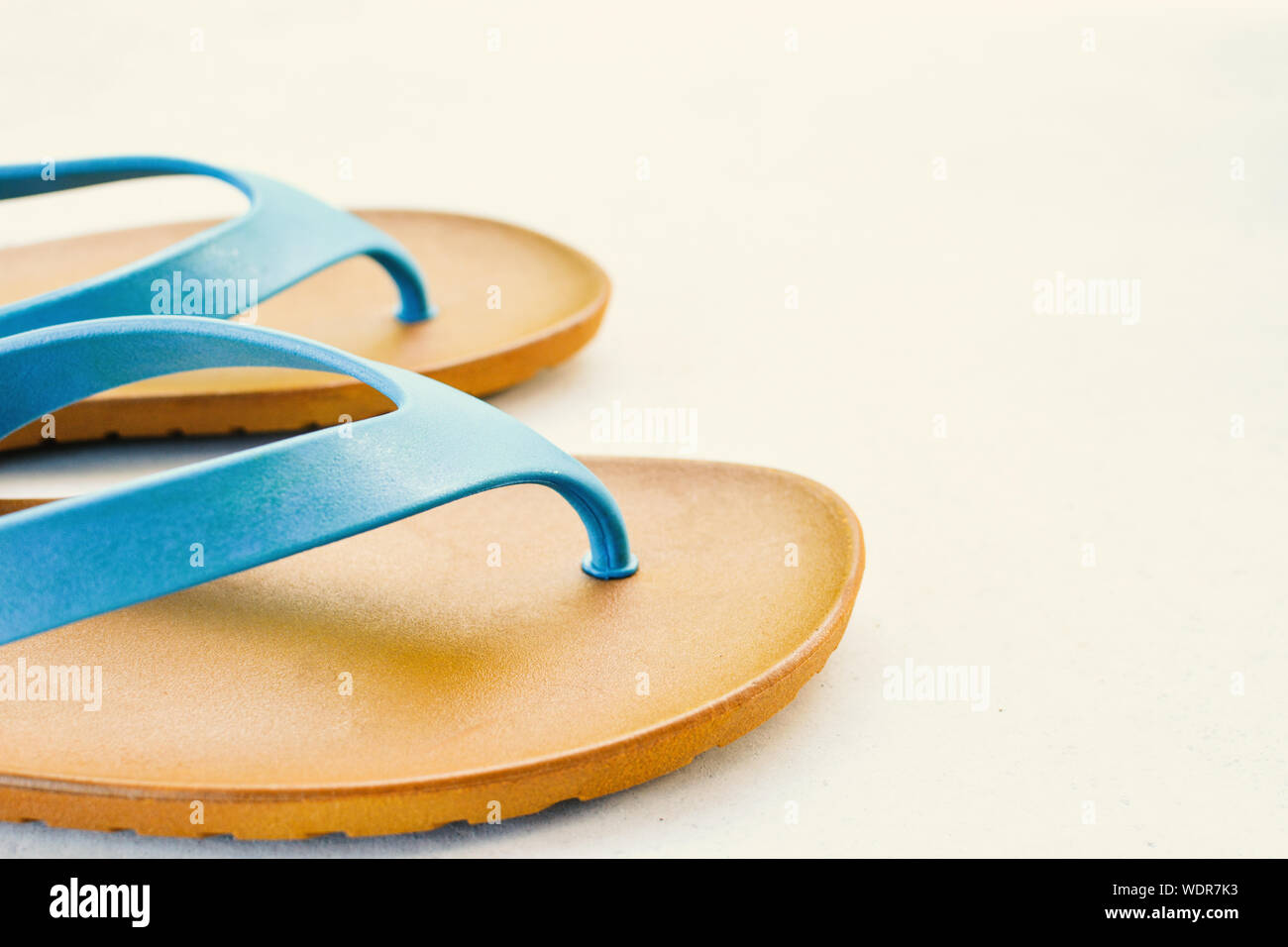 Close-up Of Flip-flop Against White Background Stock Photo