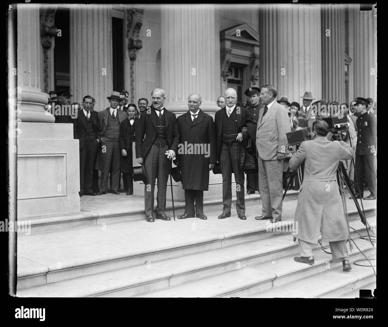 Greeted by the Vice President. Premier Ramsey MacDonald, today made his first call upon the Vice President of the United States. The group, made on the steps of the United States Capitol shown, left to right: Premier MacDonald, Vice President Curtis, Ambassador Howard and Senator Stephen G. Porter of Pittsburgh, Pa. Abstract/medium: 1 negative : glass  4 x 5 in. or smaller Stock Photo