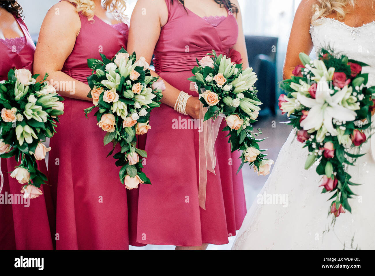 Bride And Bridesmaids Holding Flower Bouquets Stock Photo
