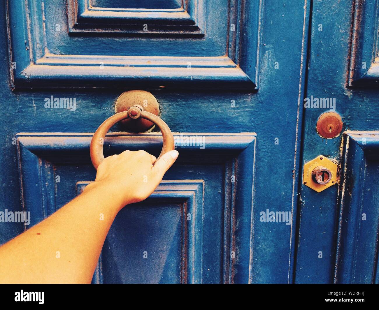 Cropped Hand Of Woman Knocking Door Stock Photo