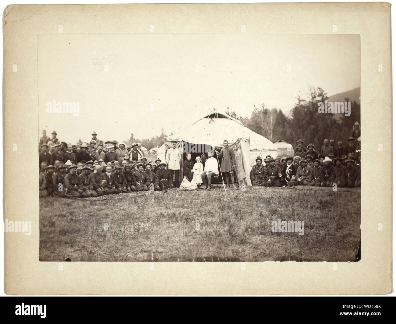 Group of Kirghiz (i.e. Kazakh) men posing with a local Russian Governor, his wife, and their child in front of a yurt Abstract/medium: 1 photographic print. Stock Photo