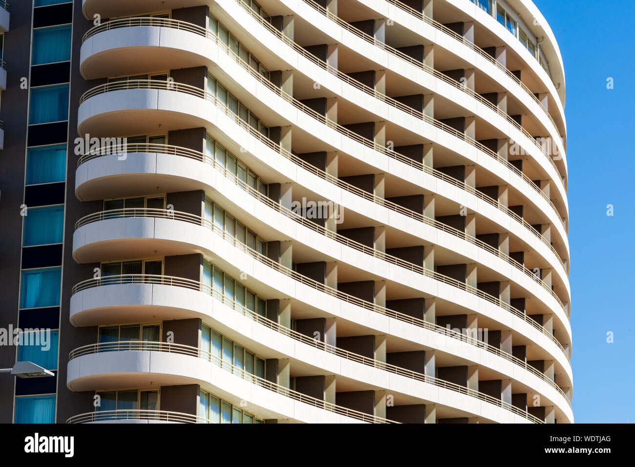 A Closeup of an Apartment Building with blue sky in the Background. Stock Photo