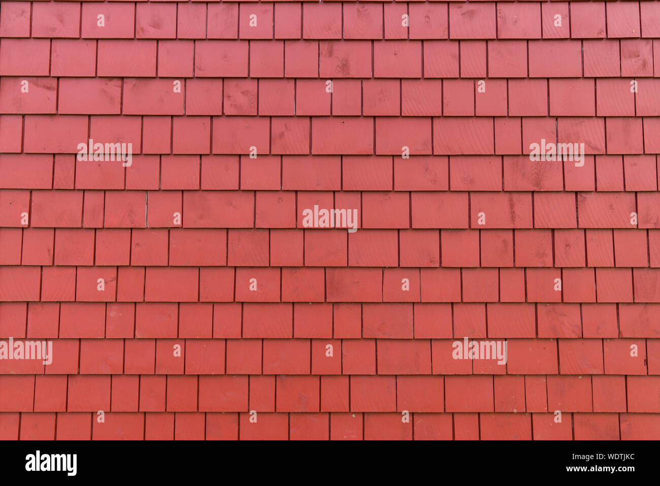 Exterior wall with bright red shingles Stock Photo