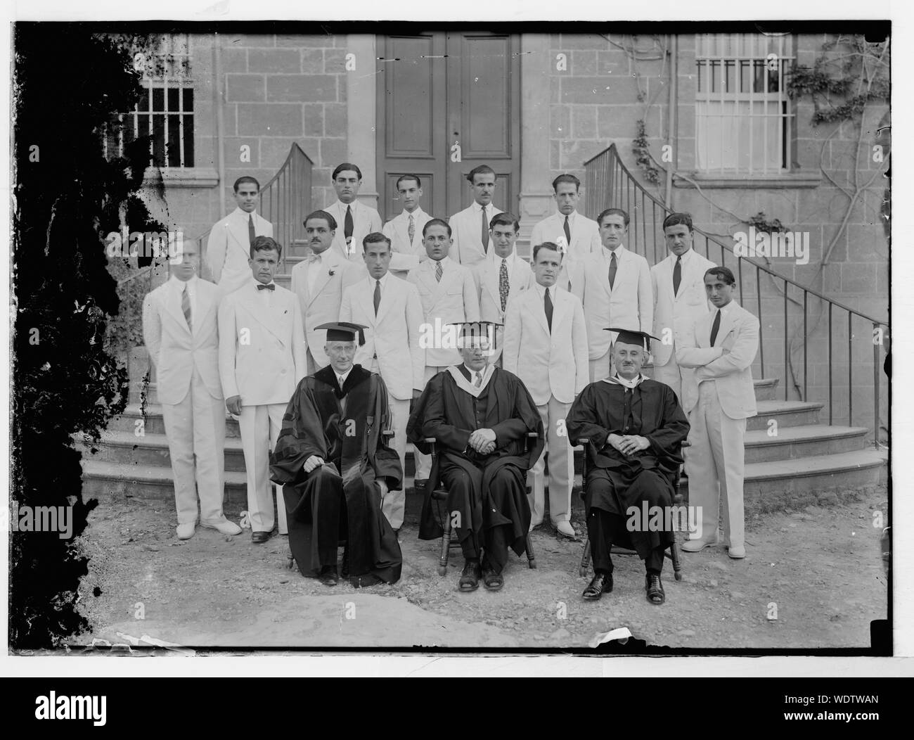 Group portrait of professors and students in front of building Abstract/medium: G. Eric and Edith Matson Photograph Collection Stock Photo