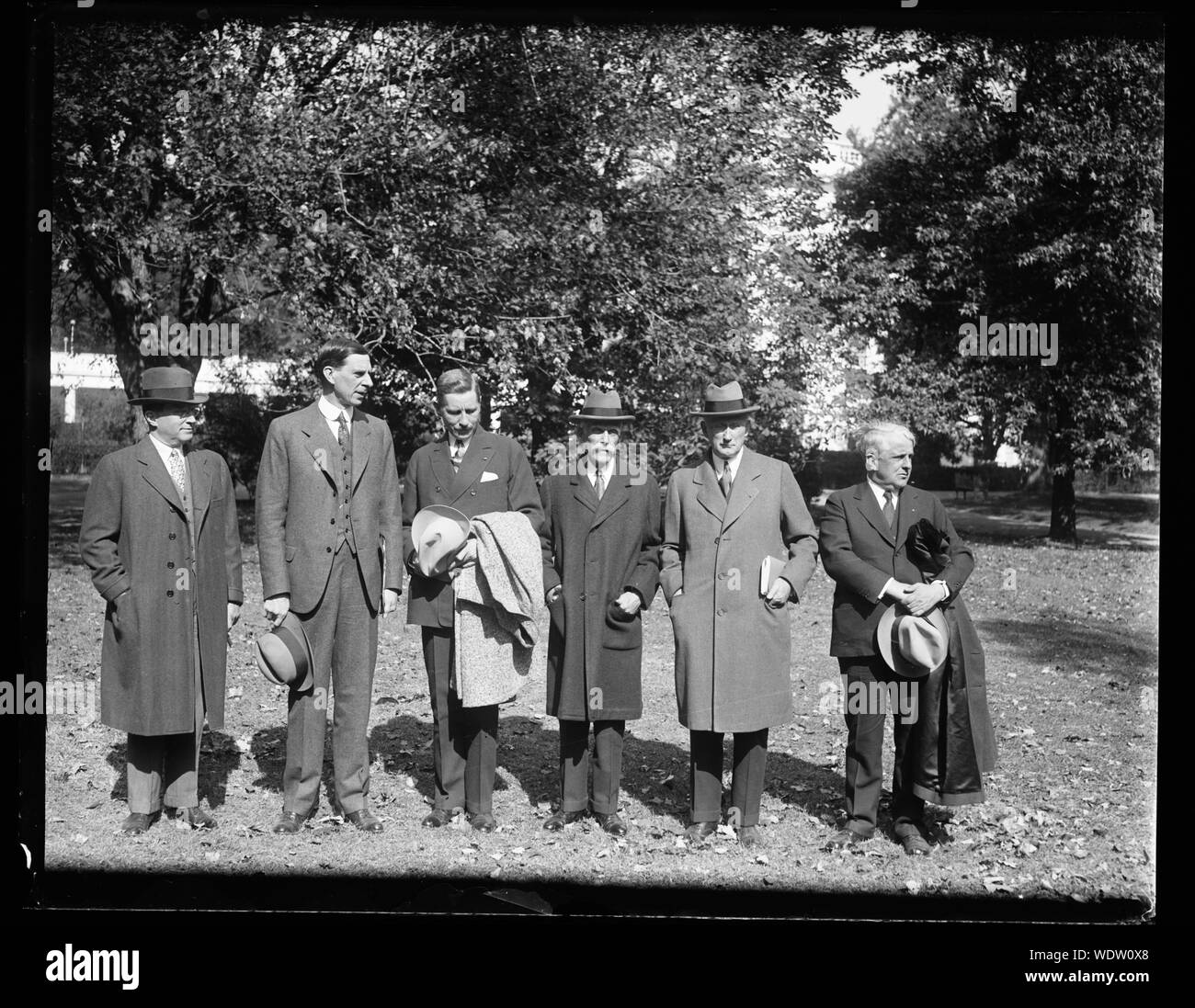 Group, left to right: unidentified, Ray Wilbur, unidentified, Andrew Mellon, unidentified, James J. Davis. White House, Washington, D.C. Abstract/medium: 1 negative : glass  4 x 5 in. or smaller Stock Photo