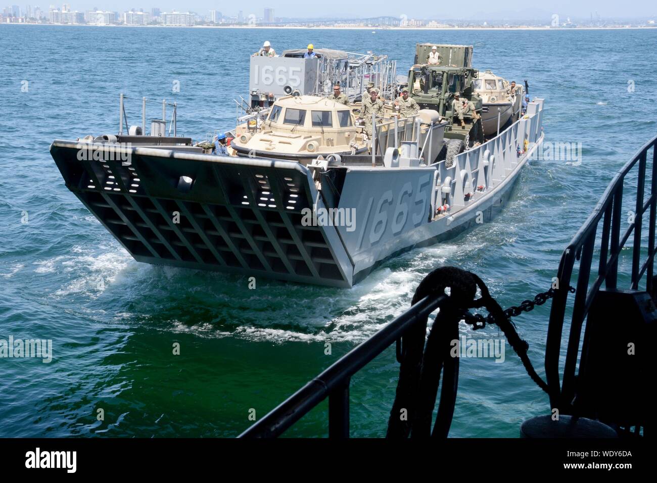 190823-N-XN177-0337 PACIFIC OCEAN (Aug. 23, 2019) – Landing Craft, Utility (LCU) 1665, attached to Assault Craft Unit (ACU) 1, prepares to enter the well deck of the dock landing ship USS Comstock (LSD 45). Comstock is currently underway conducting routine operations. This year USS Comstock will participate in the U.S. Navy Fleet Weeks in Los Angeles and San Francisco. (U.S. Navy Photo by Mass Communication Specialist 1st Class Peter Burghart/Released) Stock Photo