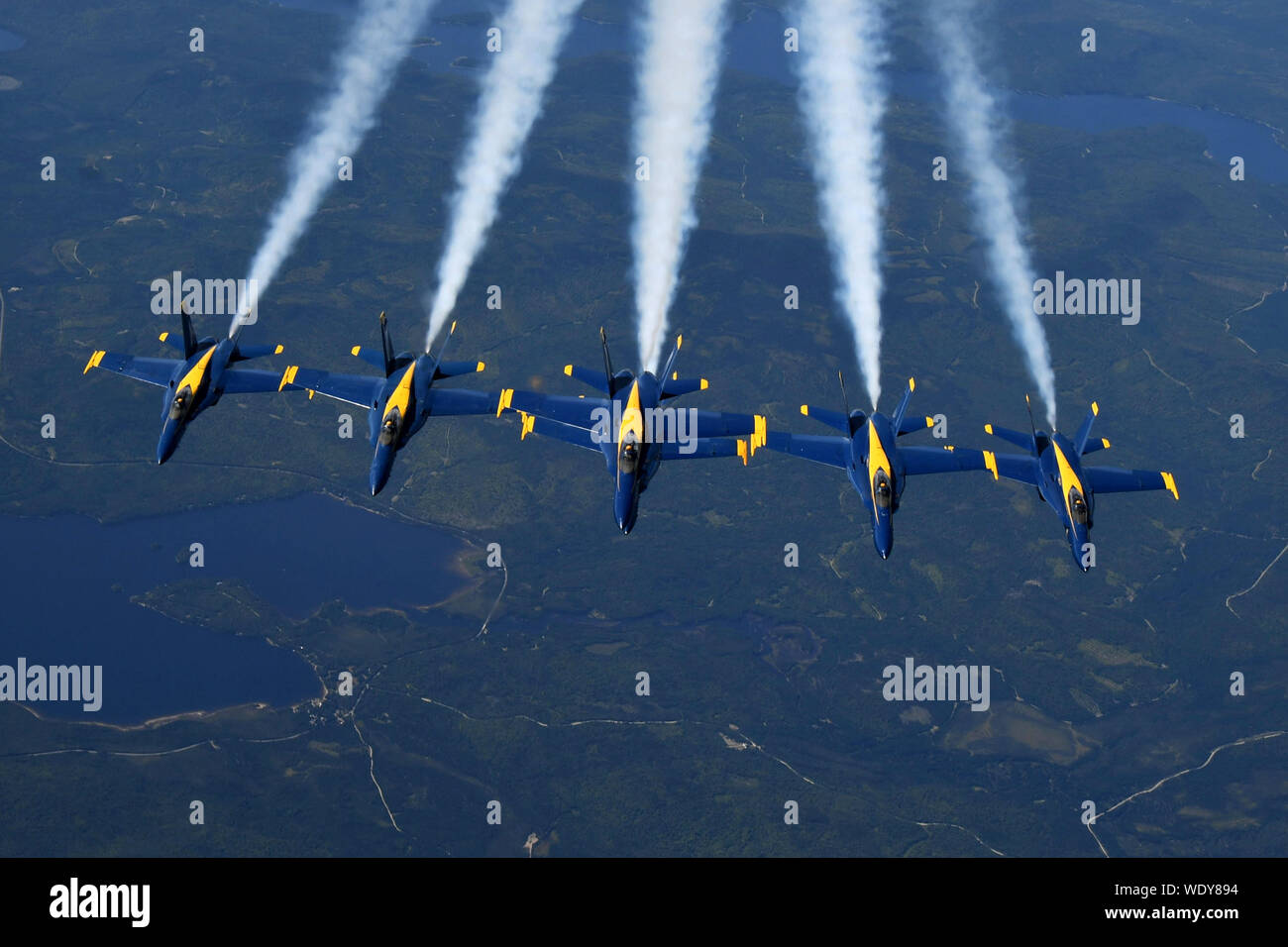 The U.S. Navy Blue Angels depart leaving condensation trails in their