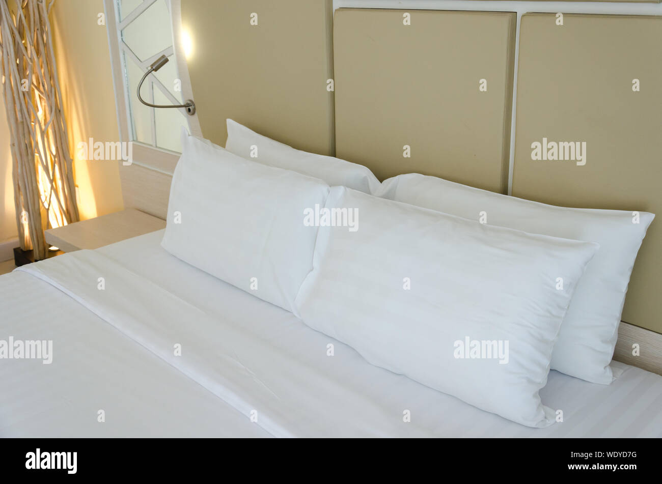White pillows on a bed in bedroom. Stock Photo