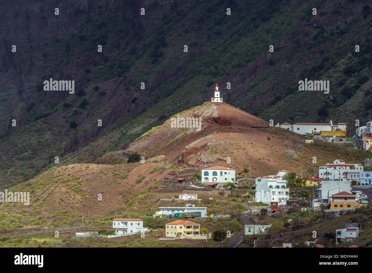Distant View Of Church On Hill Against Mountain At El Hierro Stock Photo
