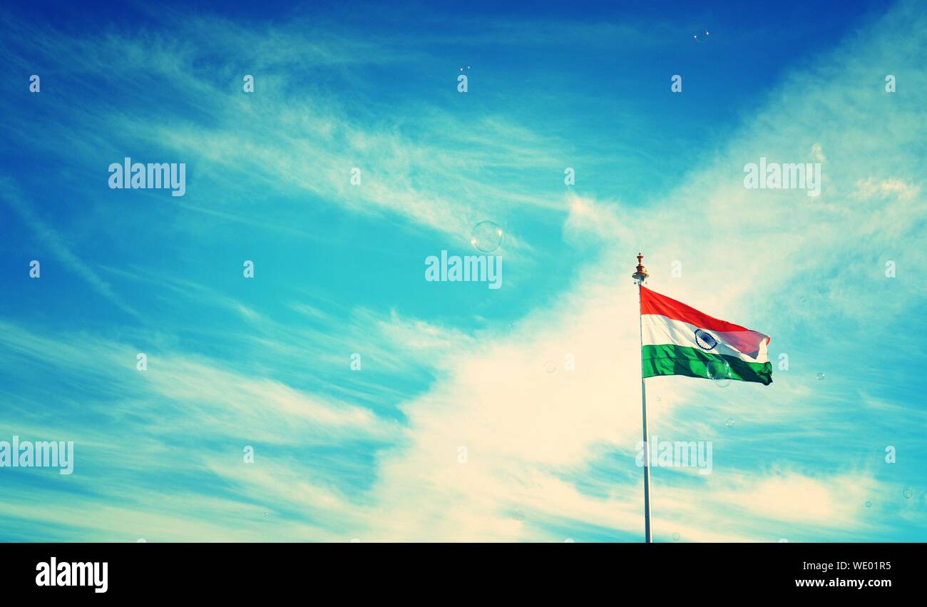 Low Angle View Of Indian Flag Against Blue Sky Stock Photo - Alamy