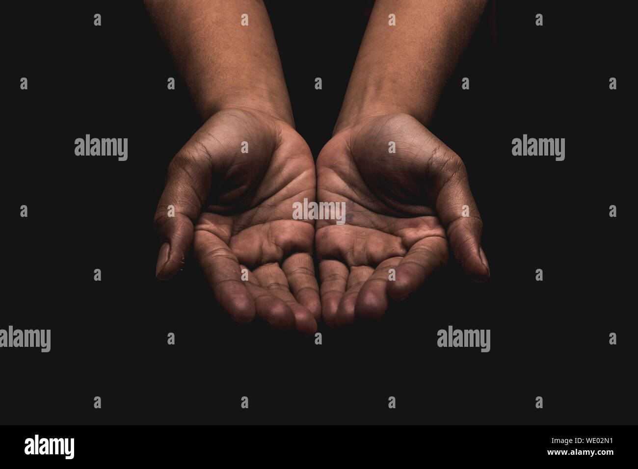 Close-up Of Hands Cupped Over Black Background Stock Photo